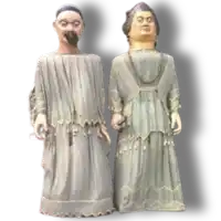 two statues of a man and a woman standing next to each other