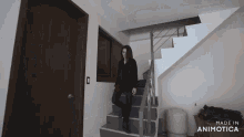 a woman is walking down a set of stairs made in animotica