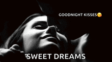 a man is kissing a woman on the cheek in a black and white photo with the words `` goodnight kisses sweet dreams '' .