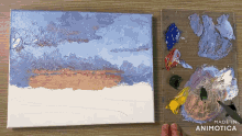 a painting of a sunset is being painted on a canvas