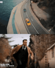 a man in a suit and tie is running down a street next to a body of water