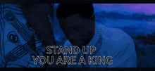 a man in a white shirt with the words stand up you are a king