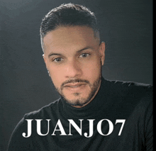 a man with a beard wearing a black shirt with the name juanjo7 on it