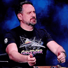 a man wearing a t-shirt that says ghostrider on it