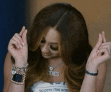 a woman wearing a necklace that says " scotty " on it