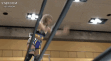 two women are wrestling in a ring with the word stardom on the bottom right