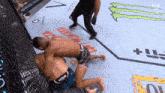 a man wearing a venum short is wrestling another man