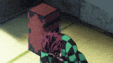 a man in a black and green checkered outfit is kneeling down in front of a wooden box