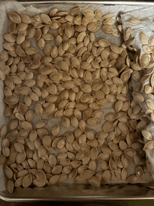 a tray of pumpkin seeds sitting on a table