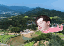 a boy with a sticker on his forehead is laying on a hillside