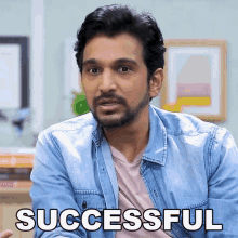 a man in a denim jacket says successful in front of his face