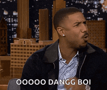 a man in a jacket says oooo dangg boi in front of a city skyline