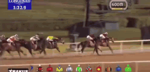 horses are racing on a track with a longines sign behind them