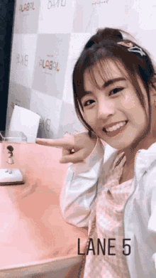 a girl taking a selfie with lane 5 written on the bottom right