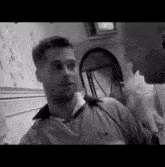 a black and white photo of two men talking to each other