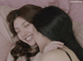 a couple of women laying on a bed with the words lingormgifss above them
