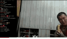 a man is eating a banana in front of a closet with chinese writing on it