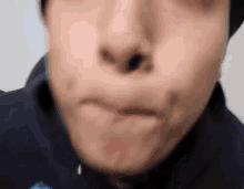 a close up of a man making a funny face with his mouth open and his nose sticking out .