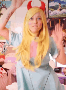 a girl in a star vs the forces of evil costume waves her hand