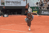 a bnp paribas ad is behind a tennis player on the court