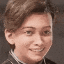 a close up of a person 's face with a smile on their face .