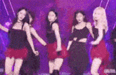 a group of women are dancing on a stage .