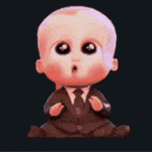 a baby in a suit and tie is sitting down with his hands folded .