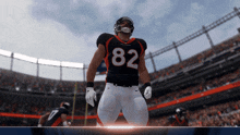 a football player with the number 82 on his jersey stands in front of a crowd