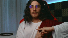 a man dressed as jesus with glasses and headphones