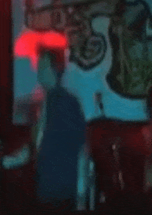 a blurry picture of a person standing in front of a screen with a drawing on it