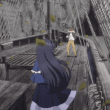 a man and a girl standing on a wooden deck with leaves blowing in the wind