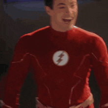 a man in a red suit stands in front of a display