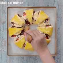a person is holding a plate of food with strawberries in the background