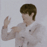 a group of young men are standing next to each other in a room and dancing .