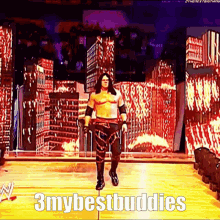a wrestler walking on a stage with the words 3mybestbuddies written on the bottom