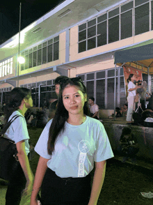 a girl wearing a white shirt that says tokyo on the front
