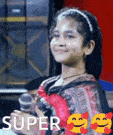 a little girl is smiling and holding a microphone with the words super written on the bottom
