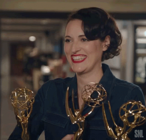 Phoebe Waller-Bridge holding three Emmy Awards
