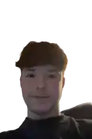 a young man with red hair and a black shirt looks at the camera
