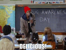 a man in a red hat is standing in front of a blackboard with the words drug awareness day written on it