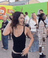 a woman is standing in front of a crowd of people .