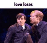 a couple of men on a stage with the words love loses above them