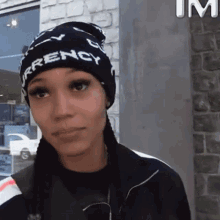 a woman wearing a hat that says currency on it