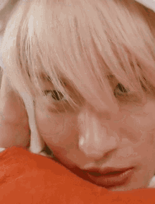 a close up of a person 's face with blonde hair