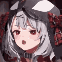 a close up of a anime girl wearing a helmet and a red plaid shirt .