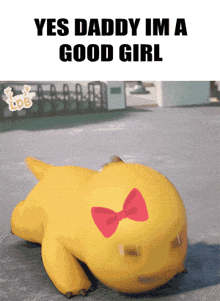 a yellow duck with a red bow on its head is laying on the ground with the words yes daddy im a good girl above it