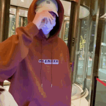 a person wearing a hoodie that says gender