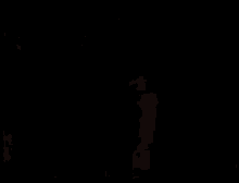 a shirtless man is standing next to another shirtless man in a dark room