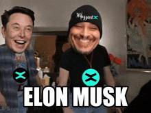 a man wearing a beanie that says mazzard laughs next to another man