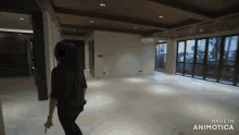 a woman is standing in an empty room with the words made in animatica on the bottom right